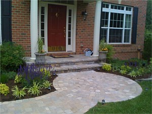 Circle paver kit leading to paver porch with landscaping